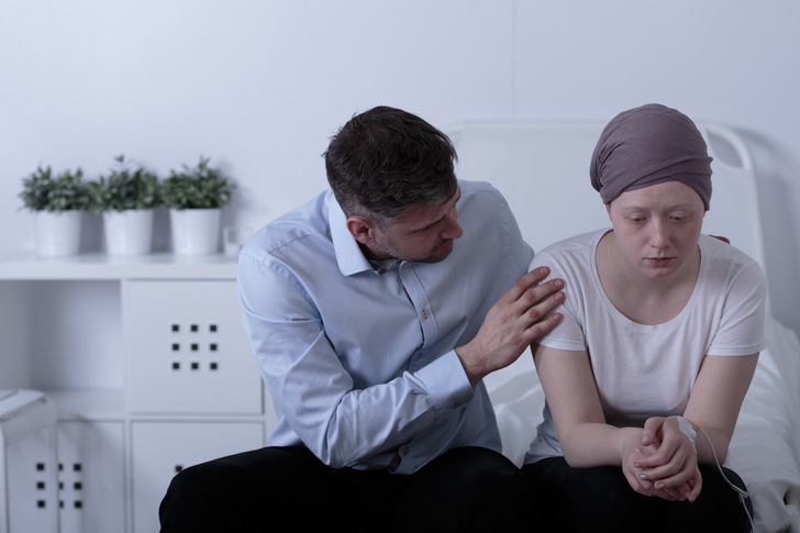Sorrowful dad is comforting his sick daughter